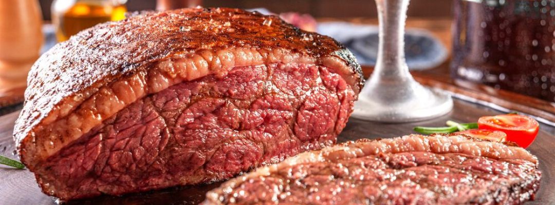 grilled-sliced-cap-rump-steak-with-two-glasses-of-beer-on-wooden-cutting-board-marble-meat-beef-brazilian-picanha